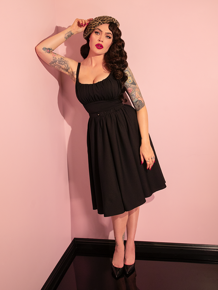 With grace and poise, Micheline Pitt presents the retro-inspired Ingenue Dress in Black from Vixen Clothing, embodying its timeless charm.