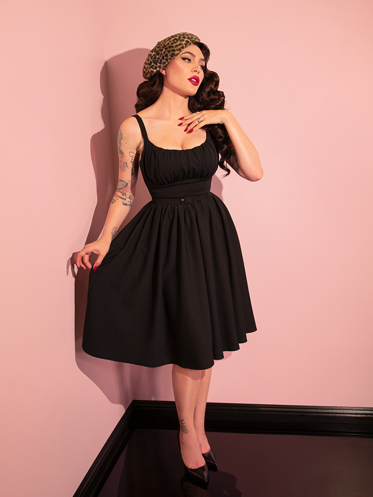 Micheline Pitt stuns while modeling the retro-inspired Ingenue Dress in Black from Vixen Clothing, capturing the essence of retro fashion.