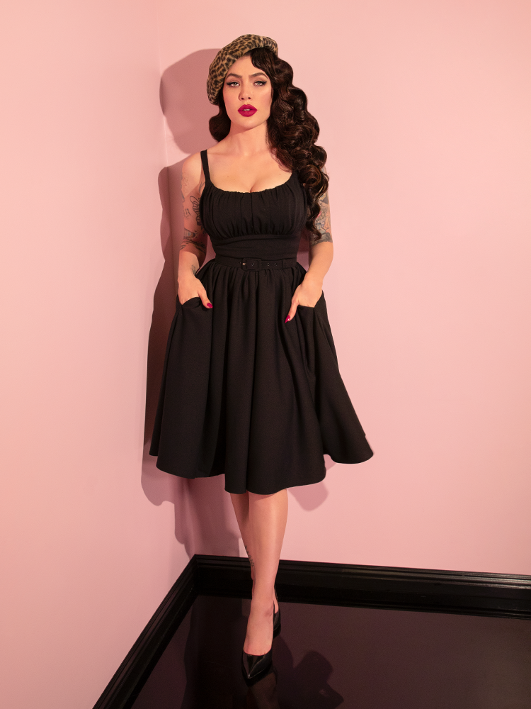 Modeling the retro-inspired Ingenue Dress in Black from Vixen Clothing, Micheline Pitt captivates with her diverse poses.