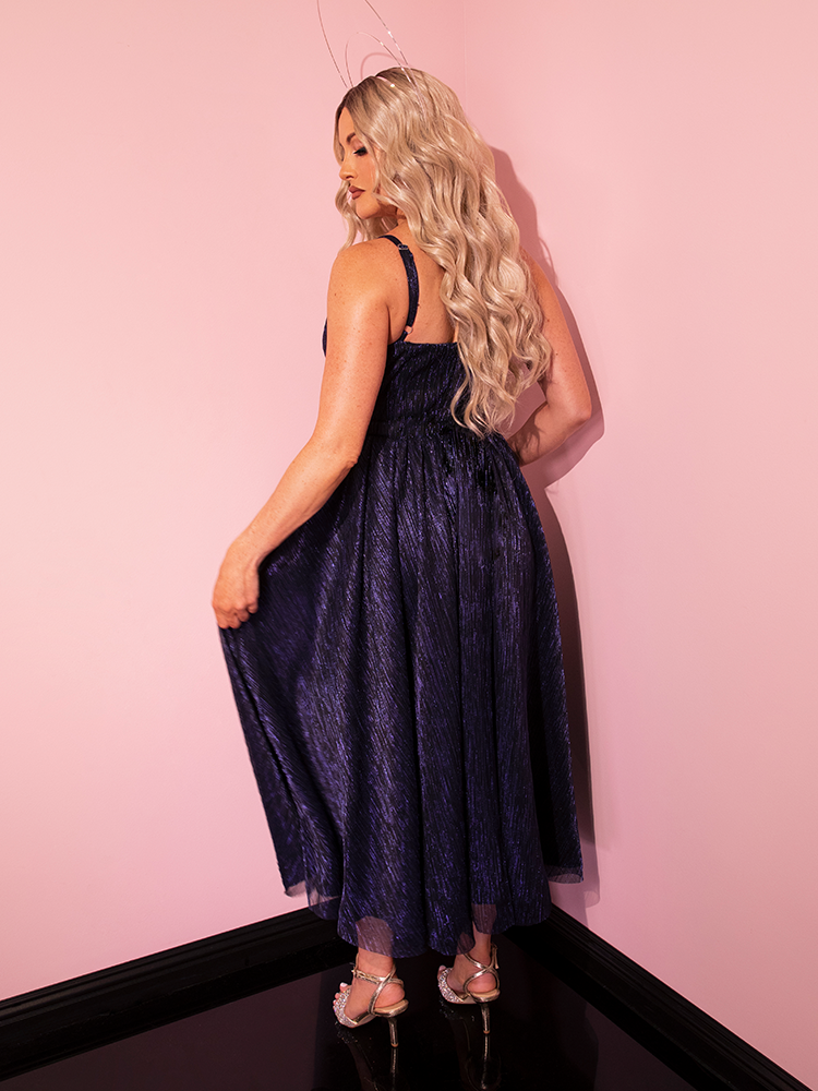 The LABYRINTH™ Jareth Gown, coupled with the Matching Cape in Midnight Blue, makes a bold and beautiful statement on this retro-inspired model from Vixen Clothing.