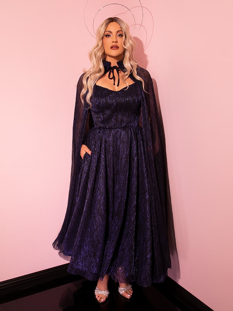 Vixen Clothing's LABYRINTH™ Jareth Gown and the Midnight Blue Matching Cape create a stunning ensemble on this model, epitomizing the essence of retro fashion.