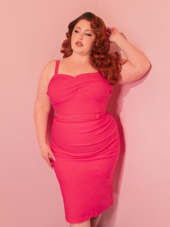 The Jawbreaker Wiggle Dress in hot pink captures the essence of retro clothing with its figure-hugging silhouette, designed to celebrate the feminine form with a bold, modern twist.