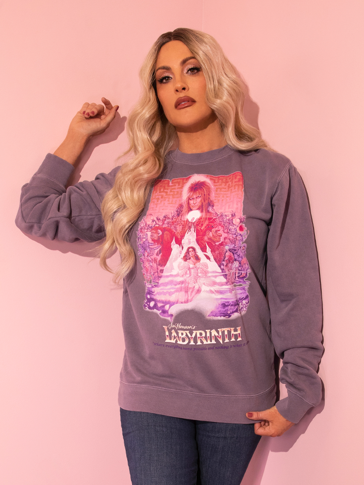 Catch a glimpse of allure as our radiant model presents the Soft Lilac LABYRINTH™ Movie Poster Sweatshirt, a treasure from Vixen Clothing's timeless collection.