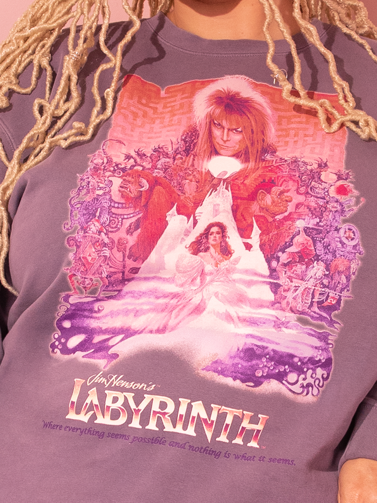 Witness elegance as our beautiful model dons the all new LABYRINTH™ Movie Poster Sweatshirt in Soft Lilac, a standout piece from Vixen Clothing's vintage lineup.