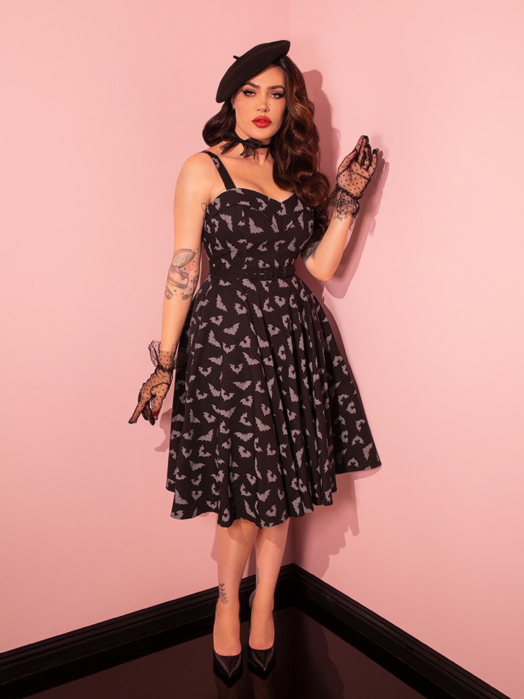 The Glow in the Dark Bat Print Swing Dress from Vixen Clothing looks amazing on this brunette model.