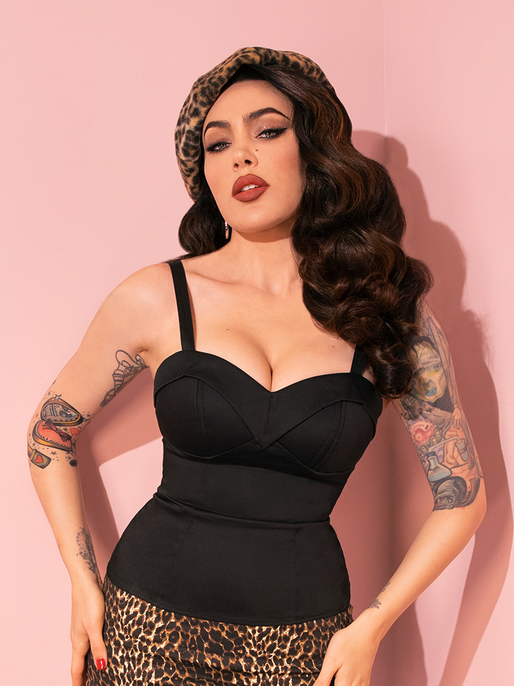 With every movement, Micheline Pitt embodies the retro-inspired Maneater Top in Black from Vixen Clothing, capturing its essence through her poses.