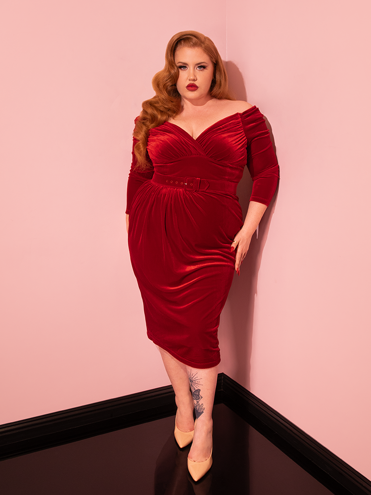 Elegance reborn: Vixen Clothing presents the Starlet Wiggle Dress in Ruby Red Velvet. Admire the timeless allure as vintage models showcase this retro gem with poise and sophistication.