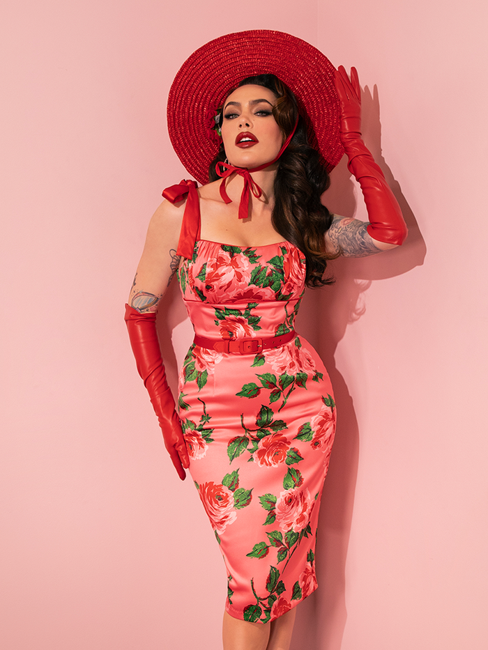 Embracing a playful vibe, female vintage models strike fun and flirty poses in Vixen Clothing's 1950s Satin Wiggle Sundress and Scarf in Pink Vintage Roses, a charming ensemble from the retro dress collection.