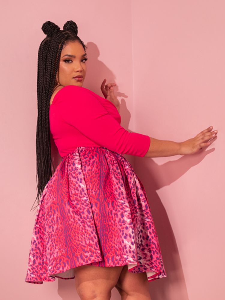 Standing tall and confident, the beautiful female model shows off the Vixen Skater Skirt in Pink Leopard Print from the gothic clothing brand La Femme en Noir.