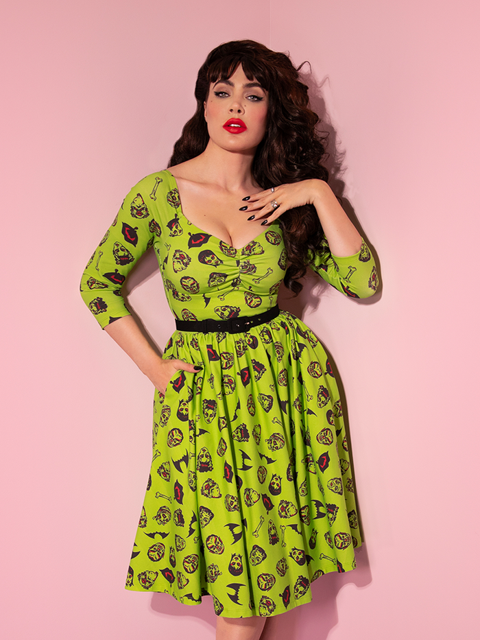 Micheline Pitt wearing the Wicked Swing Dress in Vintage Monster Mash Print from Vixen Clothing.
