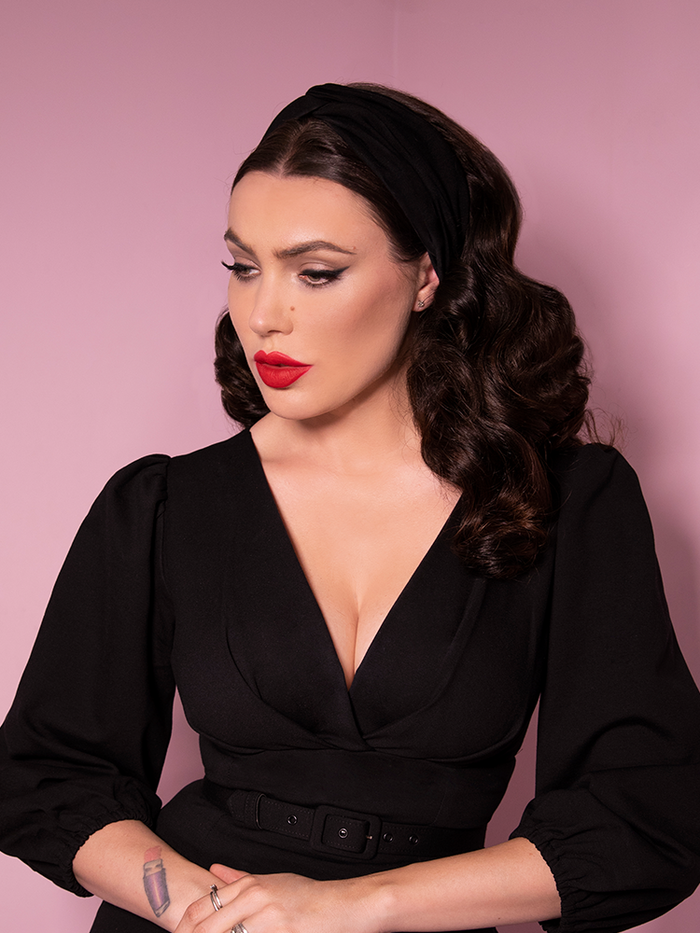 Close-up shot of Micheline Pitt in a Vintage Style Knot Headband in Black from Vixen Clothing.