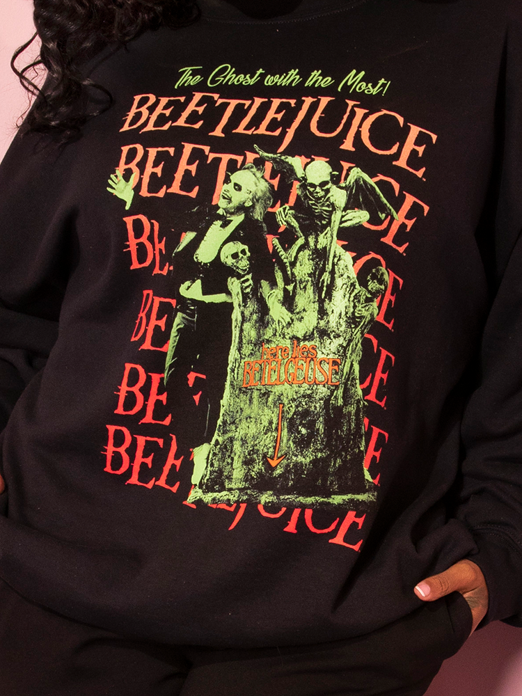 Close up of the design on the front of the Tombstone Sweatshirt being worn by female model.