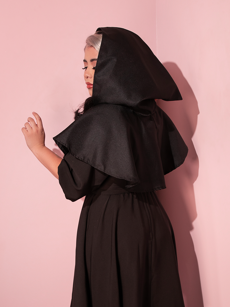 The back of the Hooded Witch Capelet in Black made by retro clothing brand Vixen Clothing.