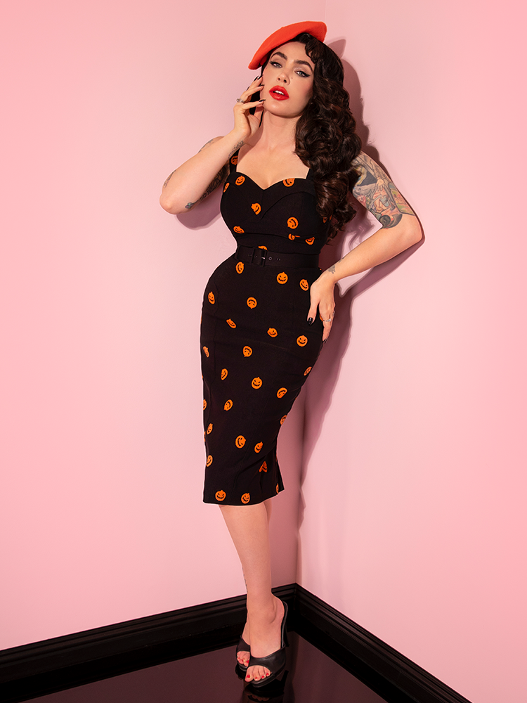 Full length shot of Micheline Pitt photographed in the Pumpkin King Maneater Wiggle Dress in Black.