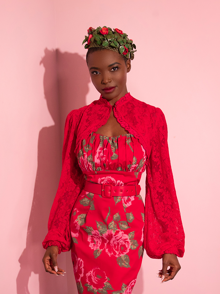 The Vixen Vintage Lace Bolero in Classic Red paired with matching retro style dress and red rose headpiece.