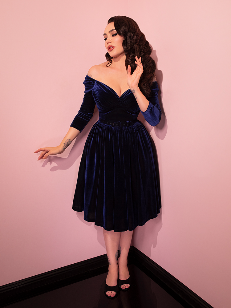 Full length shot of Micheline Pitt posing in the Starlet Swing Dress in Navy Velvet.