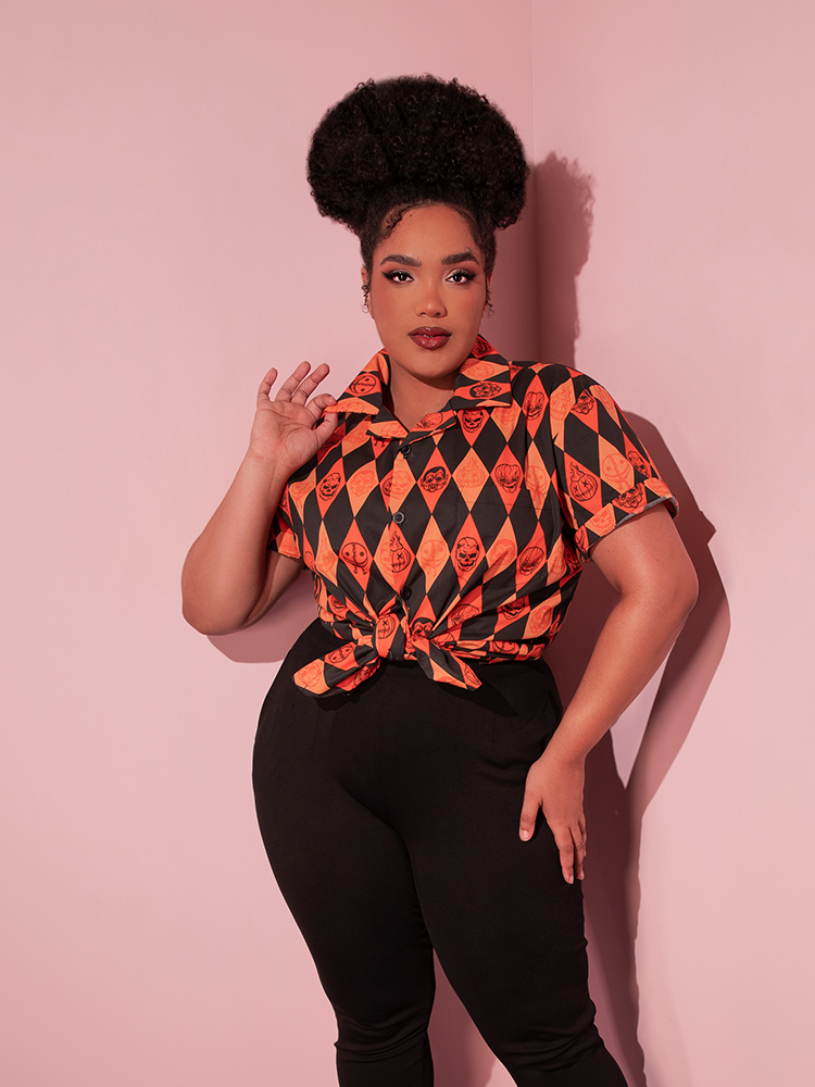 The TRICK R TREAT™ Button Up Shirt in Halloween Harlequin Print from retro clothing brand Vixen Clothing being worn by female model.