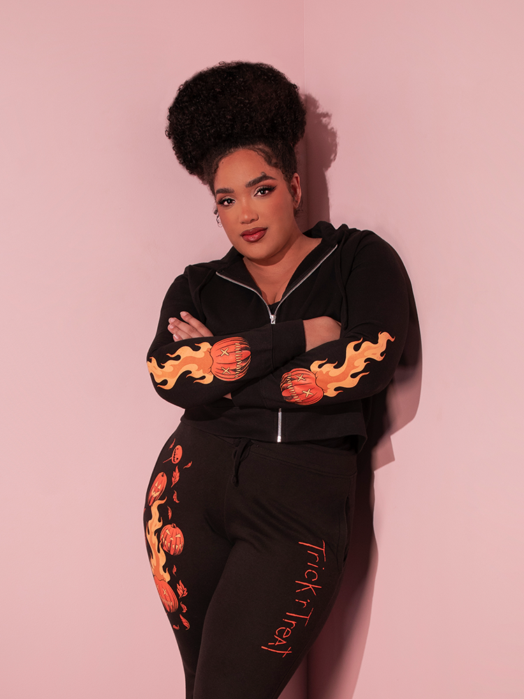 Model crossing her arms in the TRICK R TREAT™ Sam Cropped Hoodie from retro clothing brand Vixen Clothing.