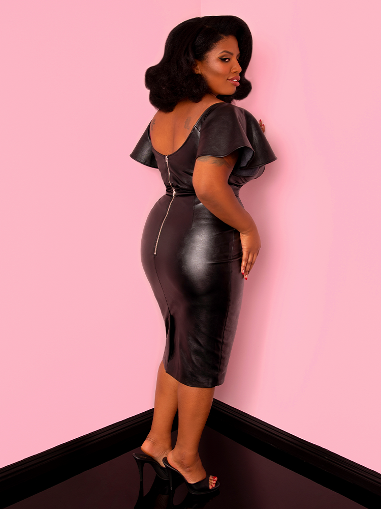 Side shot of model Aretina Cash wearing the Bad Girl Pencil Skirt in Vegan Leather from Vixen Clothing.