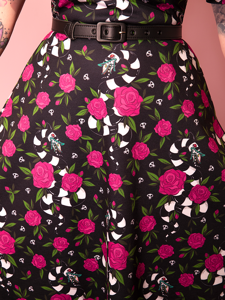 Close up of the print on the BEETLEJUICE™ Sandworm & Roses Swing Dress.