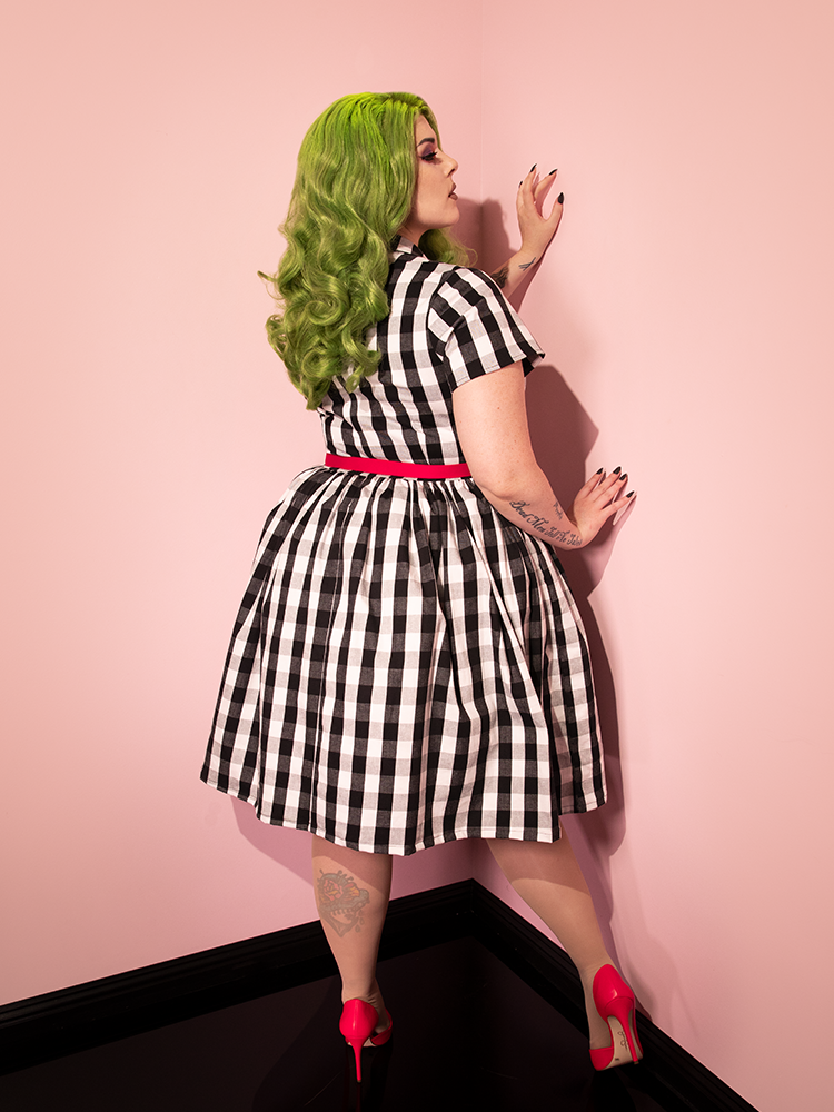 The back of the BEETLEJUICE™ Adam Maitland Shirt Dress as worn by female model with green hair.