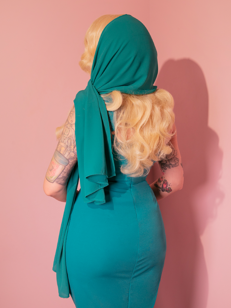 Micheline Pitt flaunts the 1950s-inspired chiffon scarf in turquoise from vintage label Vixen Clothing.