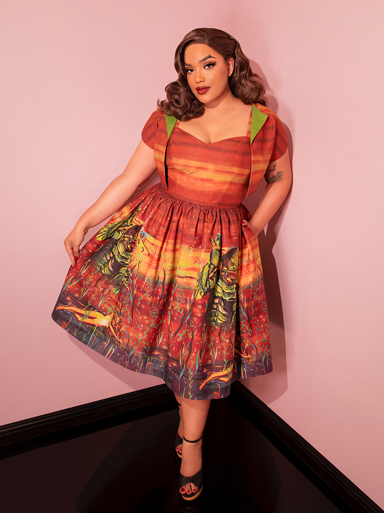 Universal Monsters: CREATURE FROM THE BLACK LAGOON™ Vintage Movie Poster Dress and Matching Bolero in Rust – Vixen by Micheline Pitt Universal Monsters: CREATURE FROM THE BLACK LAGOON™ Vintage Movie Poster Dress and Matching Bolero in Rust – Vixen by Micheline Pitt
