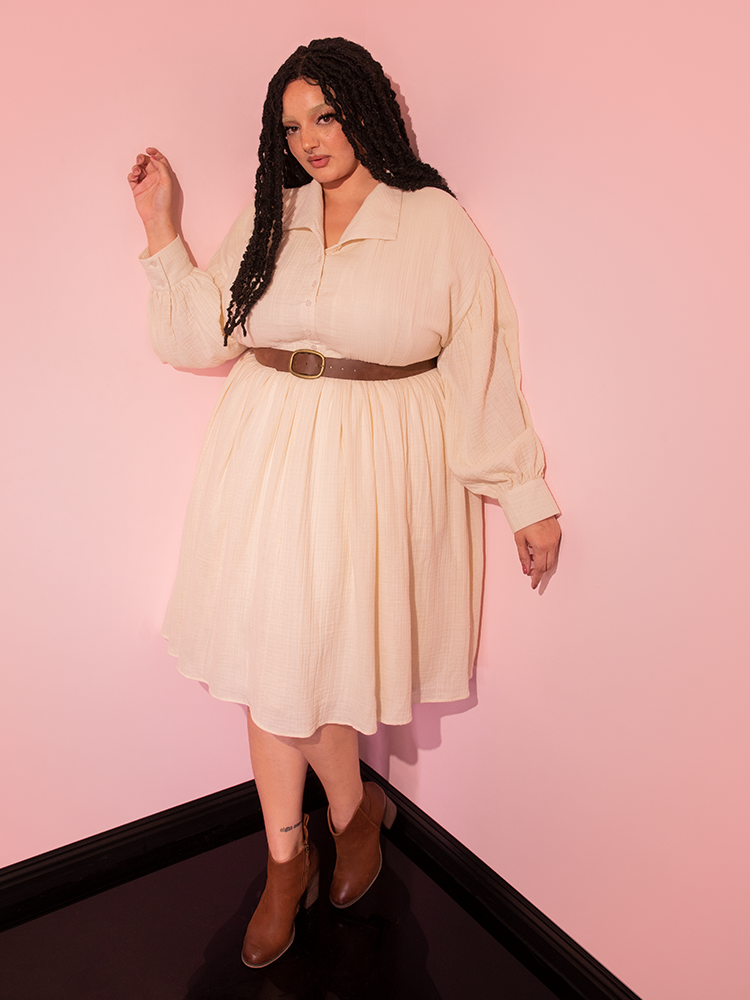 Unveil the allure of the Cream Fantasy Shirtdress, complete with a Faux Leather Belt, worn flawlessly by our retro-inspired model, brought to you by Vixen Clothing.