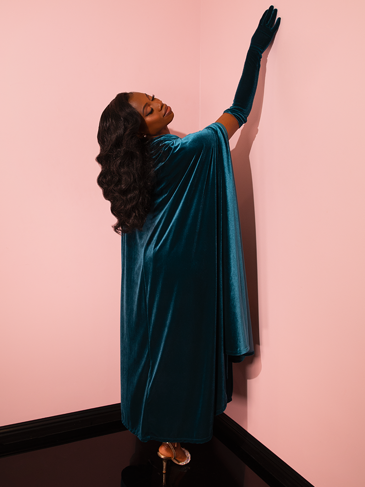 Retro charm takes center stage as gorgeous models strike poses to showcase the timeless appeal of the Golden Era Gown and Glove Set in Teal Velvet from Vixen Clothing.
