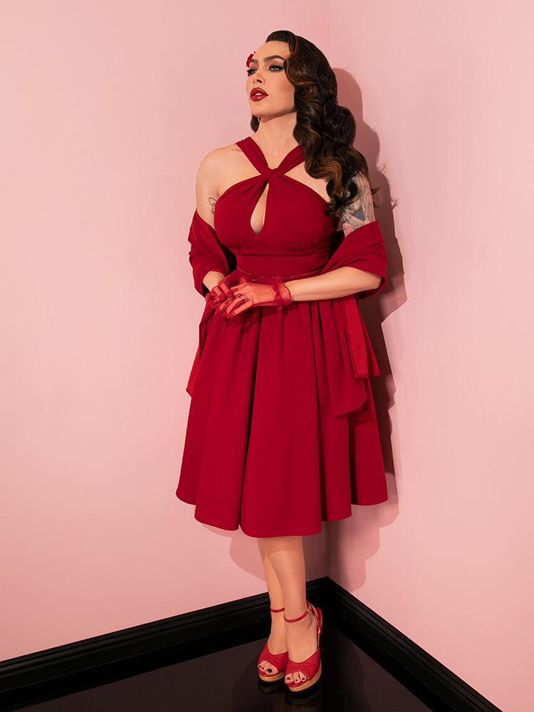 Vixen Clothing's iconic Ruby Red Golden Era Swing Dress and Scarf steal the show as vintage models exhibit an array of captivating poses.