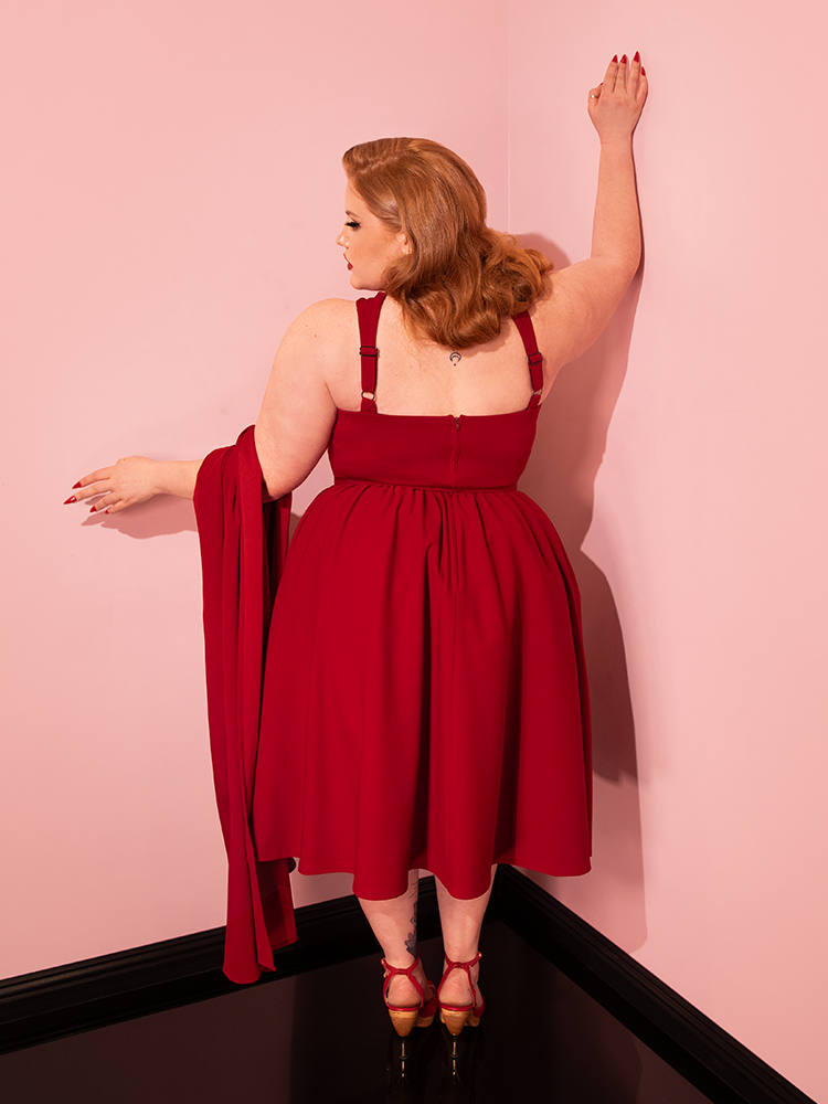 Graceful vintage models take center stage, showcasing the Golden Era Swing Dress and Scarf in Ruby Red from Vixen Clothing with timeless style.