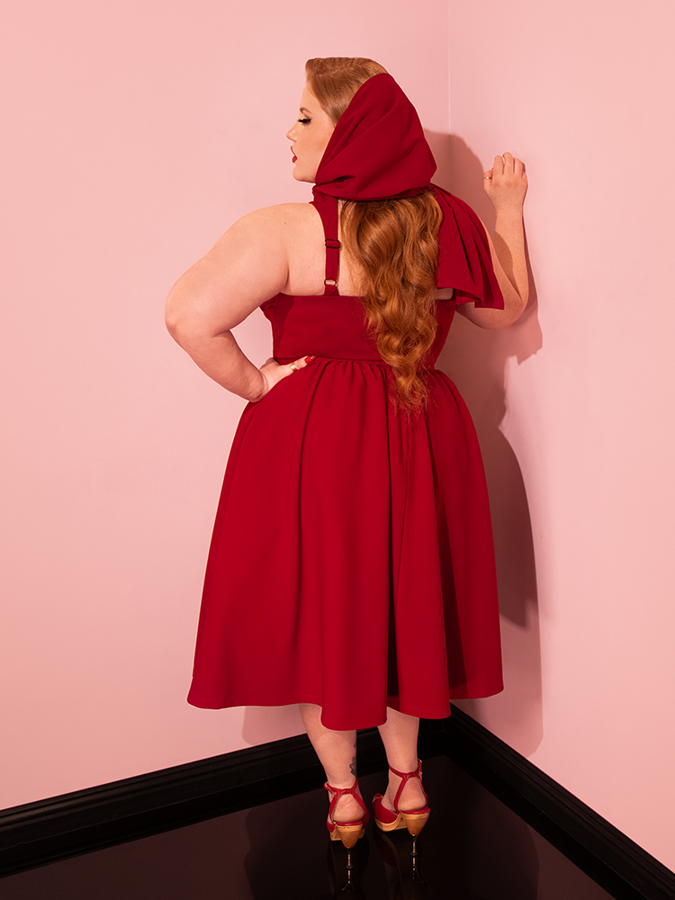 Mesmerizing retro-inspired poses unfold as models flaunt the sophistication of the Ruby Red Golden Era Swing Dress and Scarf by Vixen Clothing.