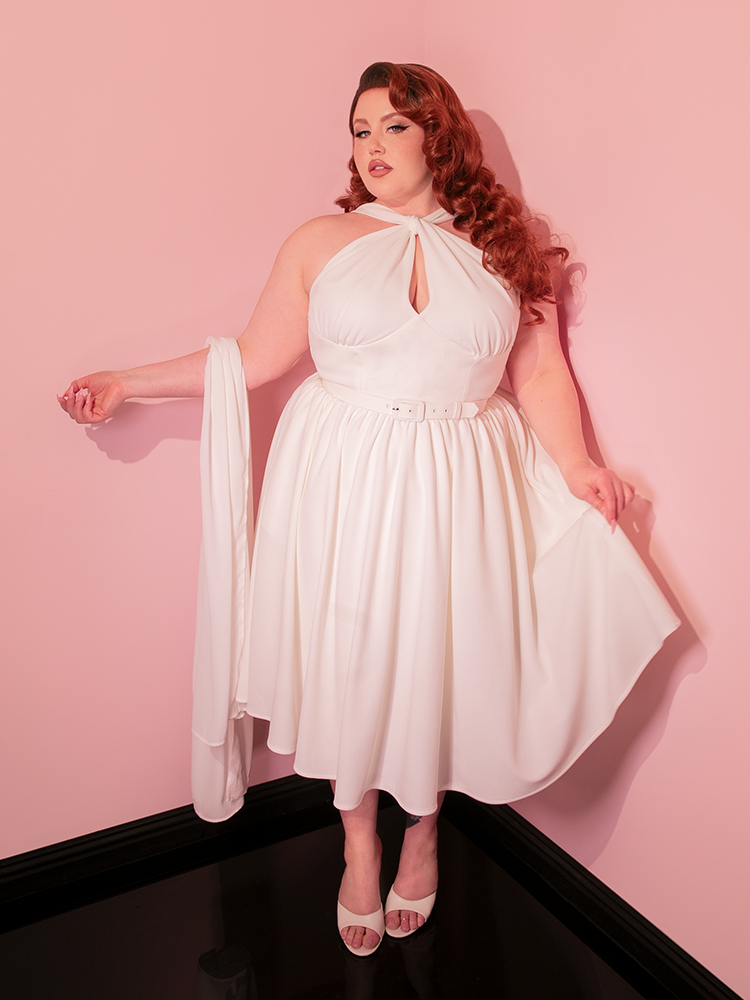 The soft, flowing Chiffon Scarf and the classic silhouette of the Golden Era Swing Dress in Ivory are your passport to the past, offering a glimpse into the cherished world of retro and vintage clothing.