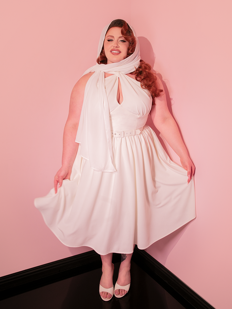Invoke the timeless beauty of vintage-inspired fashion with the Ivory Golden Era Swing Dress and Chiffon Scarf, a duo that pays tribute to the elegance and charm of retro clothing, making every occasion a moment to remember.