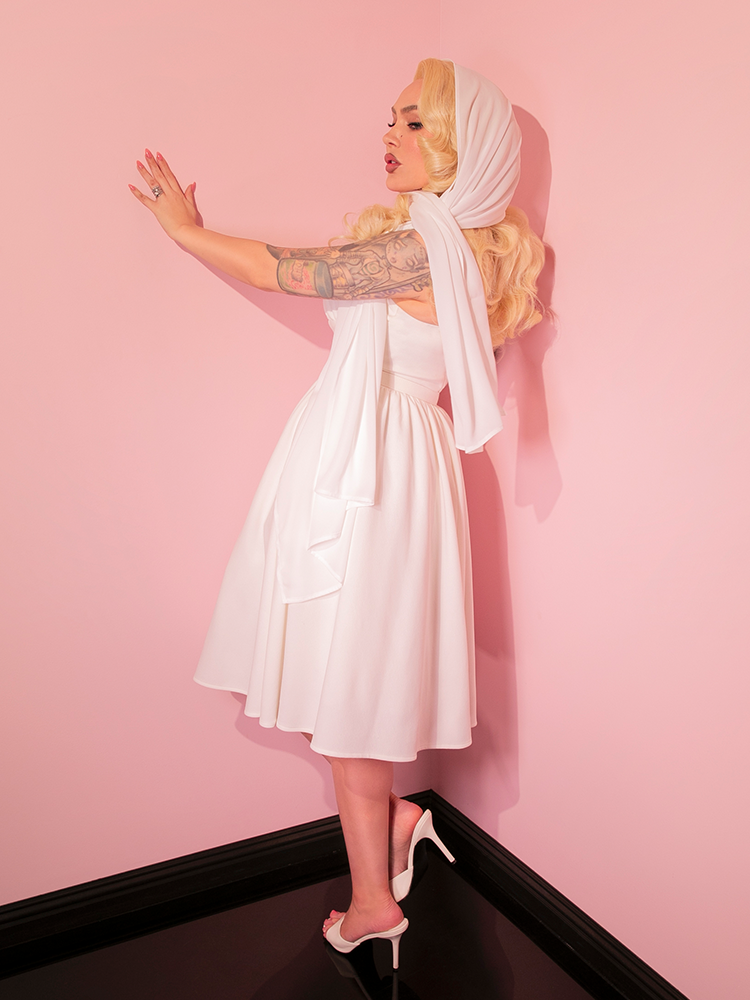 The ethereal elegance of the Chiffon Scarf paired with the timeless Ivory Golden Era Swing Dress perfectly captures the essence of retro clothing, bringing a piece of the past forward into today's fashion landscape.