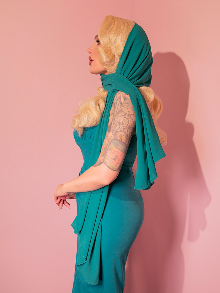 Micheline Pitt showcases the turquoise chiffon scarf, a nod to the 1950s, from the retro brand Vixen Clothing.