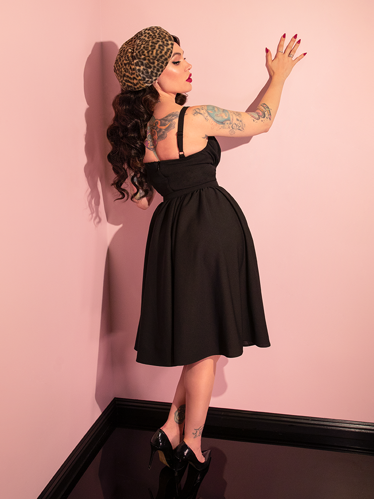 Micheline Pitt brings the retro-inspired Ingenue Dress in Black from Vixen Clothing to life with her dynamic poses and timeless elegance.