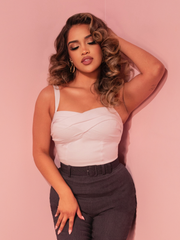 Pair the Jawbreaker Top in Ivory with your favorite retro skirt for a look that exudes classic Hollywood sophistication and timeless charm.