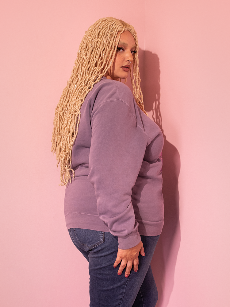 Behold the charm of the all new LABYRINTH™ Movie Poster Sweatshirt in Soft Lilac, gracefully worn by our captivating model, courtesy of Vixen Clothing's retro offerings.