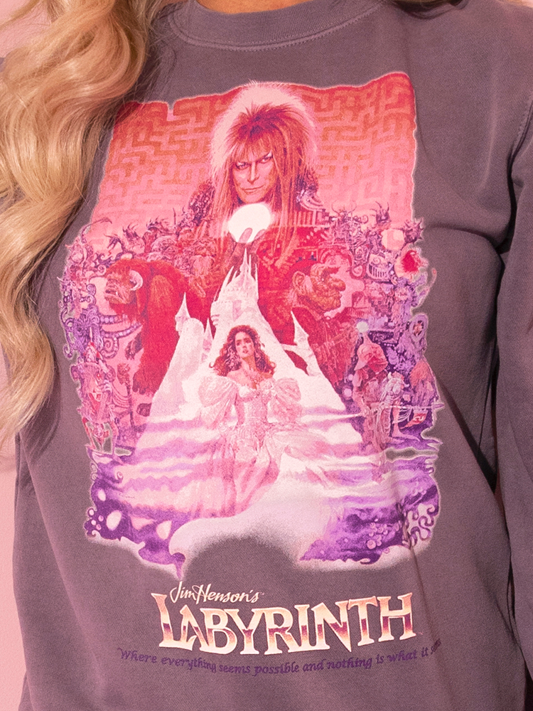 A vision of style and grace: our enchanting model showcases the all new LABYRINTH™ Movie Poster Sweatshirt in Soft Lilac, brought to you by Vixen Clothing's nostalgic designs.