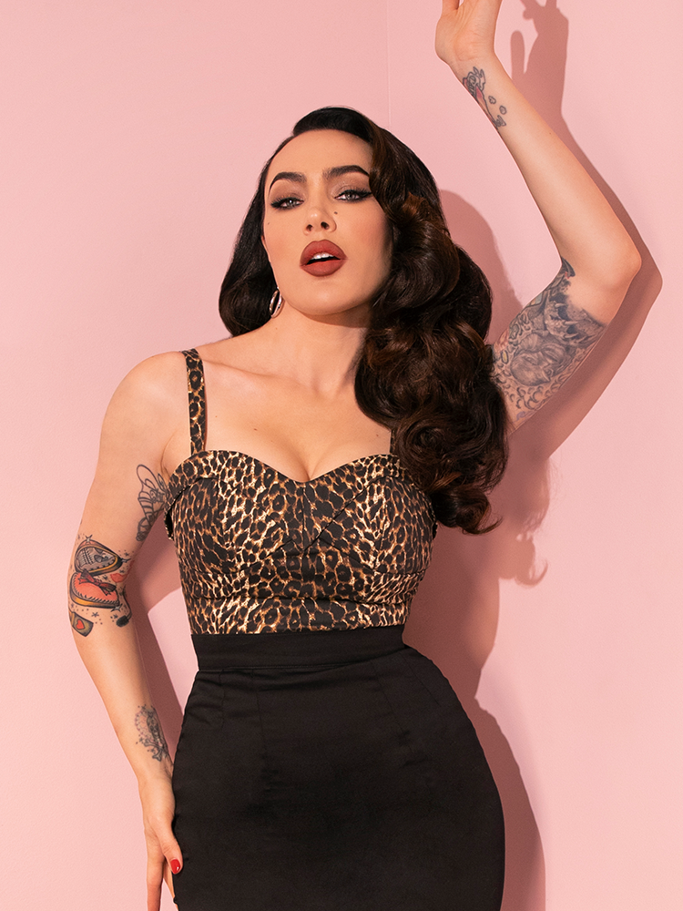 Micheline Pitt brings retro chic to life with playful poses in the Maneater Top in Wild Leopard Print from Vixen Clothing.