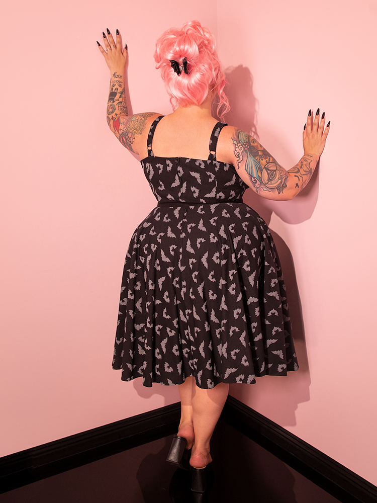 Discover the allure of the Maneater Swing Dress with its Glow in the Dark Bat Print in Black, elegantly modeled by our stunning female model, and crafted by Vixen Clothing, the go-to retro dress brand.