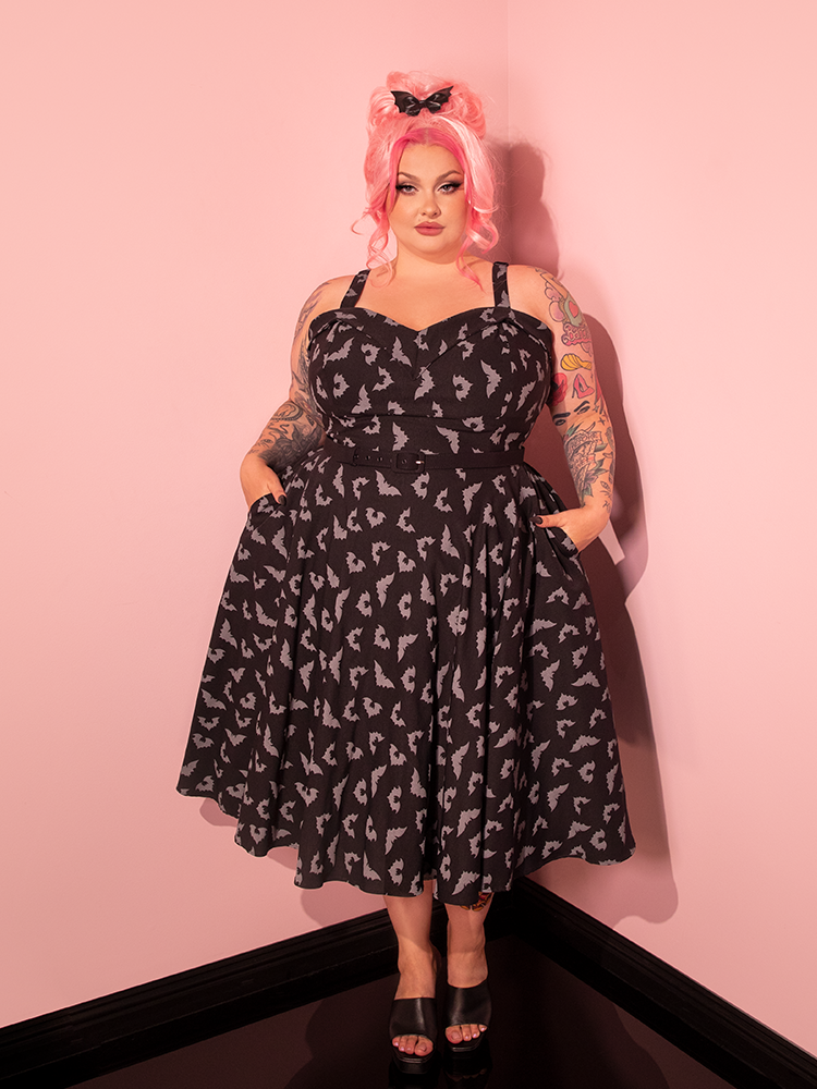 Vixen Clothing's Glow in the Dark Bat Print Swing Dress is elegantly showcased by a stunning pink-haired model.