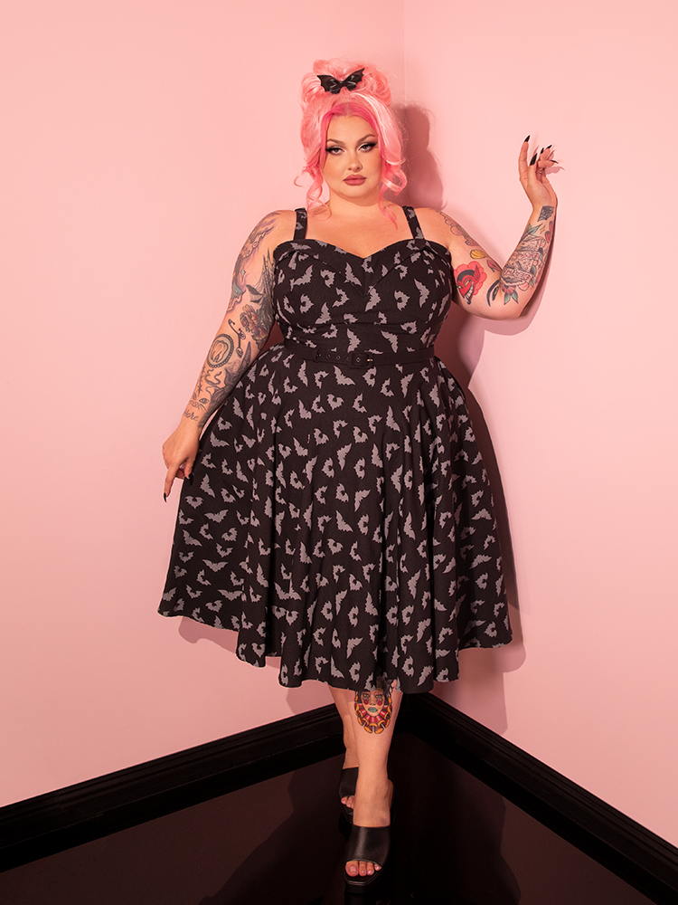 The Maneater Swing Dress in Glow in the Dark Bat Print by Vixen Clothing looks divine on this vintage style model.