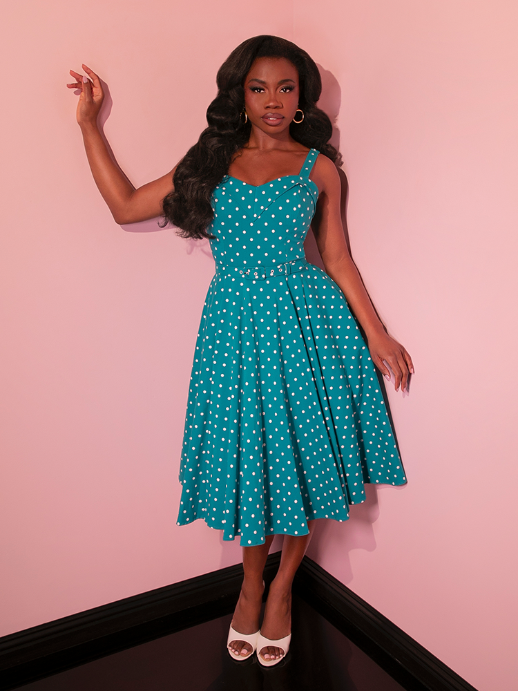 Make a statement in the Maneater Swing Dress, a piece that captures the essence of vintage dresses with its eye-catching Teal Blue Polka Dot design.