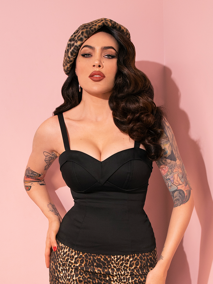Micheline Pitt's dynamic poses highlight the retro-inspired Maneater Top in Black from Vixen Clothing, making it a standout piece in the collection.