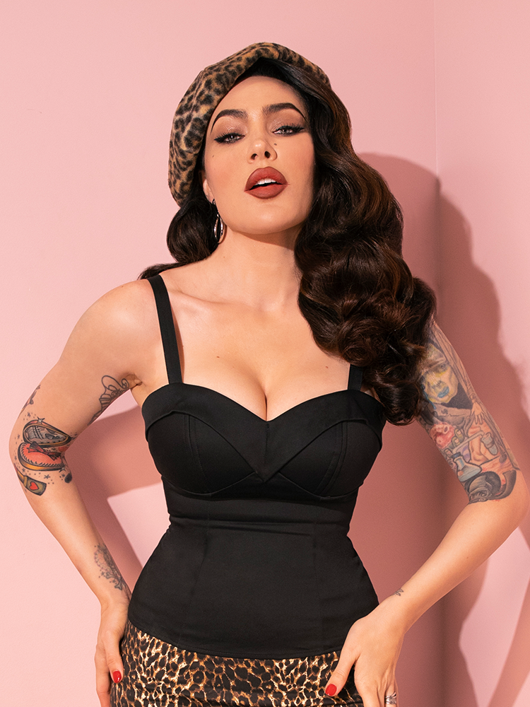 Micheline Pitt exudes confidence while modeling the retro-inspired Maneater Top in Black from Vixen Clothing, adding her unique flair to each pose.