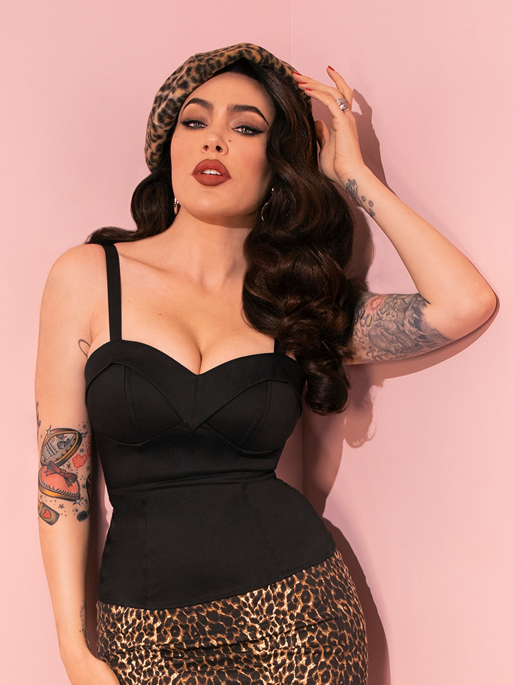The beautiful Micheline Pitt showcases the retro-inspired Maneater Top in Black from Vixen Clothing, exuding confidence in her poses.