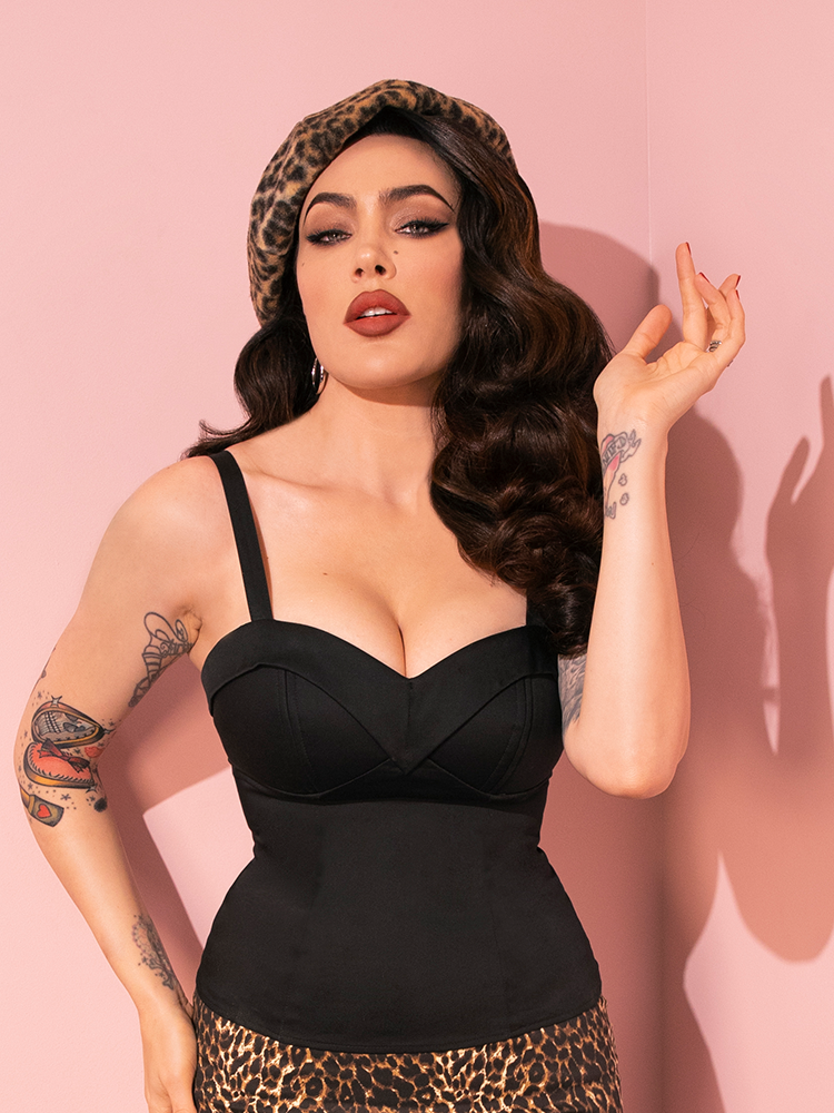 The retro-inspired Maneater Top in Black from Vixen Clothing shines as Micheline Pitt strikes a variety of captivating poses.
