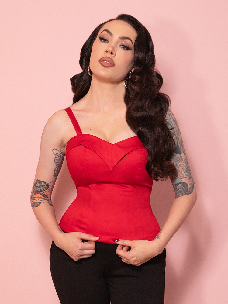 Classic Hollywood–inspired red Maneater top with wide straps and a flattering, sculpted bodice.